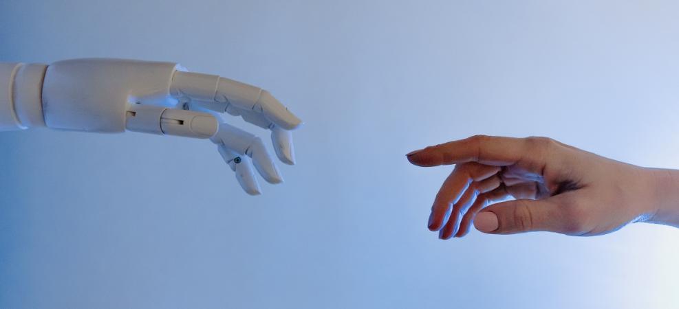 Robot hand reaching out to human hand