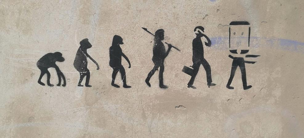 Cave drawing of species evolving from an ape to a mobile device