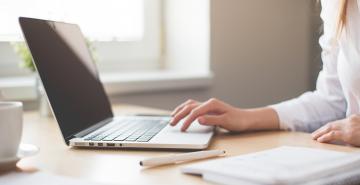 Woman working on laptop from home office 