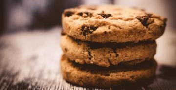 Chocolate chip cookies in a stack of 3 on bench